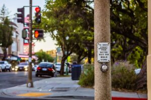 A close-up of a pedestrian push button and traffic light, illustrating Denver Pedestrian Accident Law and the duty of care.