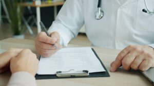 Doctor discussing medical forms during a patient consultation regarding medical power of attorney in Colorado